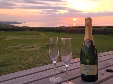 At the farm shop watching the sunset with a bottle of local fizz