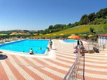 The swimming pool and paddling pool are surrounded by a large sun terrace