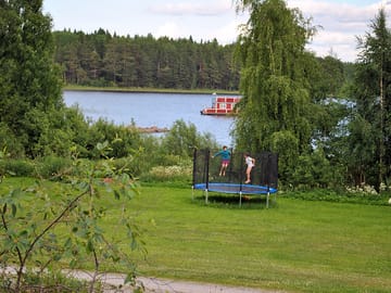 There is a trampoline near the lake