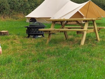 Picnic bench alongside the bell tent