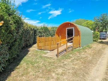 Camping pod with a fence