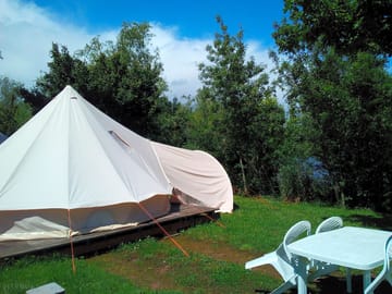 Pitch with tipi, table and chairs