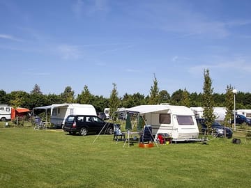 Camping field with space for parking and awnings