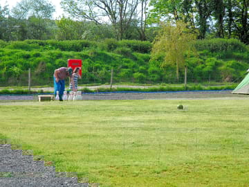 Enjoying a family game of skittles - one of many available outdoor games on the campsite