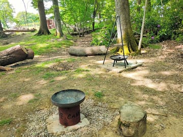 A place for a barbecue and a bonfire in the woods.