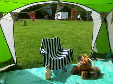 Inside a tent, showing a basket of wine and eggs produced on the farm and vineyard