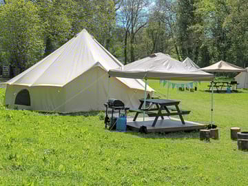 One of our flower bell tents, lots of room to play and run around the bell tents
