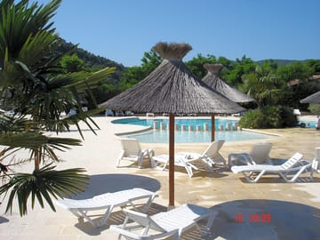 Swimming pool area and sun loungers