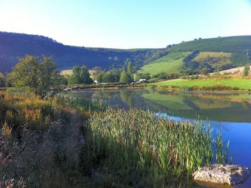 Vivid colours, blue sky and a still lake, a perfect stroll around the swimming lake