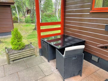 Table and four chairs outside the lodges