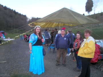 Visitors around large camp fire