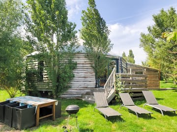 Exterior view of the 95m² Giant Yurt and its garden furniture/terrace