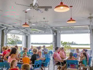 Have dinner in the tiki bar, among the breeze off the water