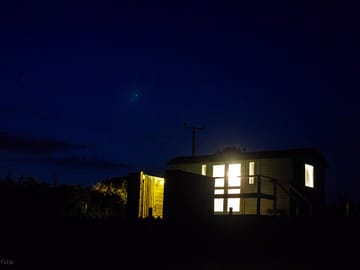 The hut and bath all lit up at night