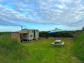 The pitch with picnic bench and parasol