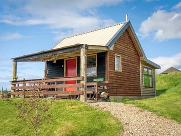Graham's bothy with its front veranda, overlooking the main pond