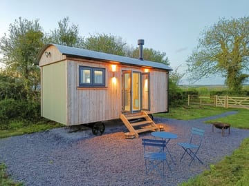 The exterior of the hut and its outdoor space