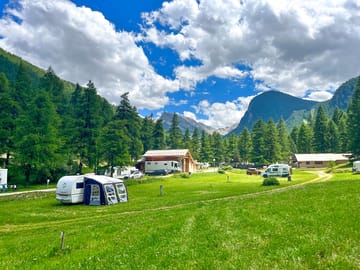 Pitches surrounded by trees and mountains