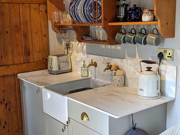 Fully equipped kitchen with fridge-freezer, microwave, induction hob, kettle and toaster