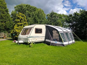 Caravan with large awning and outdoor furniture