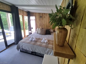 King bed with fluffy towels and blankets provided