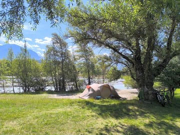 Pitch between the river and trees
