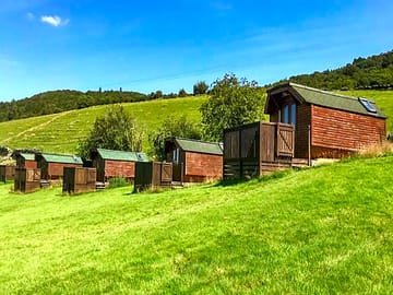 Pods with a hilly backdrop