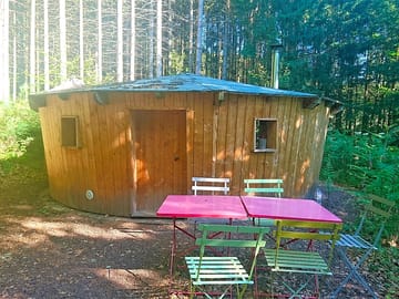 Wooden yurt with outdoor tables