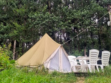 Bell tent sheltered by trees