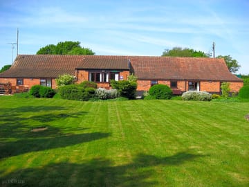 A beautifully-furnished, single-storey barn divided into holiday cottages