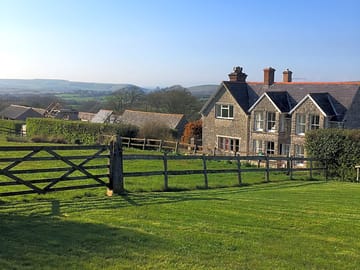 View of the farmhouse from the caravan site across to corfe castle