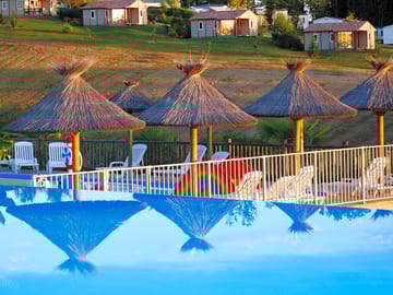 Parasols around the heated outdoor swimming pool