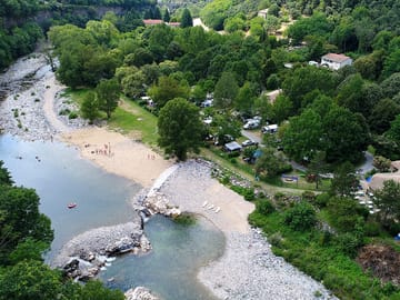 Aerial view of campsite and beach along the river