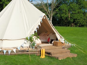 Bell tent on a wooden platform