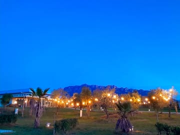 The site lit up at night