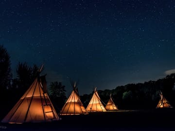 Tipis lit up at night