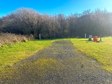 Hardstanding pitch with grass around