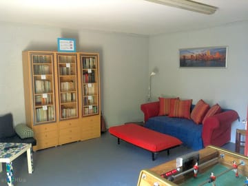 Common room with tv, library, board games and tables football