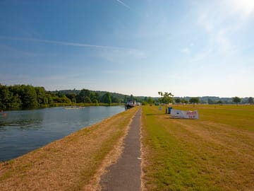The riverbank bathed in sunshine, near the motorhome pitches