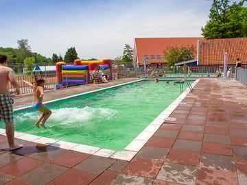 Swimming pool and paddling pool, separated by a fence