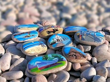 Local scenes painted on stones