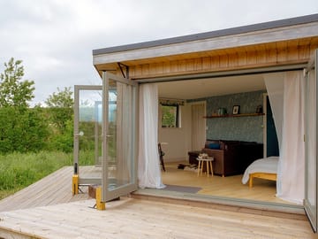 Deck and open doors looking into Tawny's living area