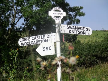Direction sign pointing to studland summer camp!