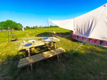 Bell tent with a picnic bench