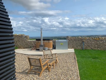 Bracken camping pod with a log-fired hot tub and views down to the coast