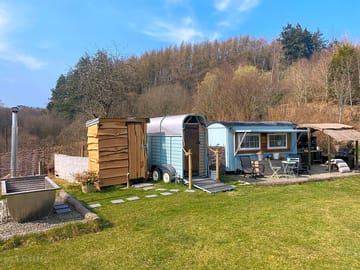 View of hot tub, toilet, shower, Shepherd's hut & kitchen