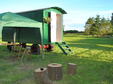 A gazebo is installed outside the hut