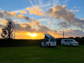 Van Friends enjoying the view to the sea from their pop up