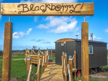 Entrance sign and bridge to your hut.