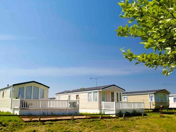 Exteriors of silver and bronze two-bedroom caravans